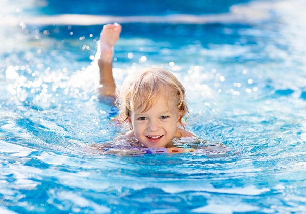 Child Learning To Swim. Kids In Swimming Pool.