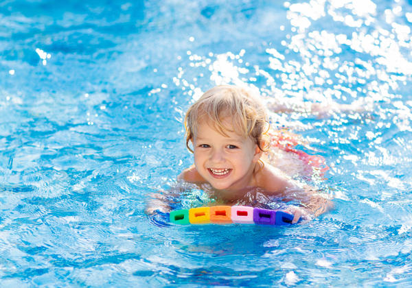 Child Learning To Swim. Kids In Swimming Pool.