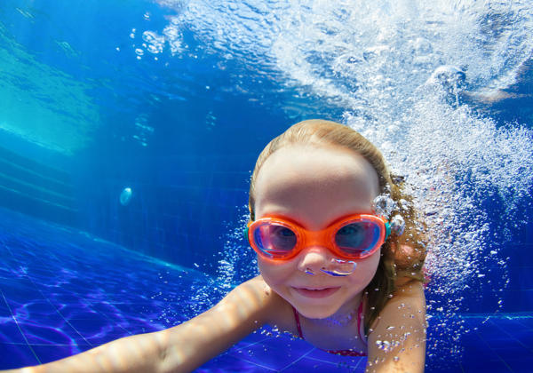 Happy Family In Swimming Pool. Smiling Child In Goggles Swim, Di